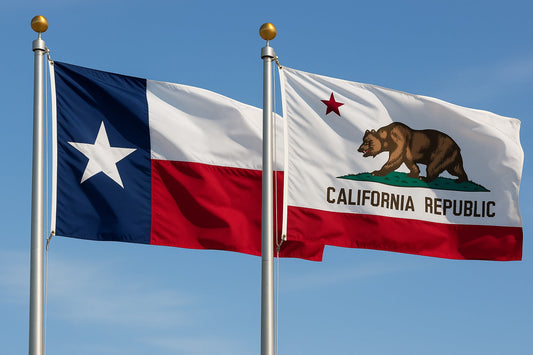  Texas and California state flags flying side by side on flagpoles against a clear blue sky