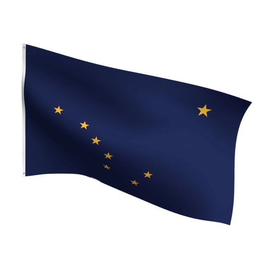 Alaska state flag waving against a blue sky with white clouds