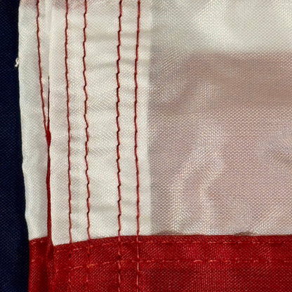 Close-up of a red, white, and blue fabric with visible stitching.